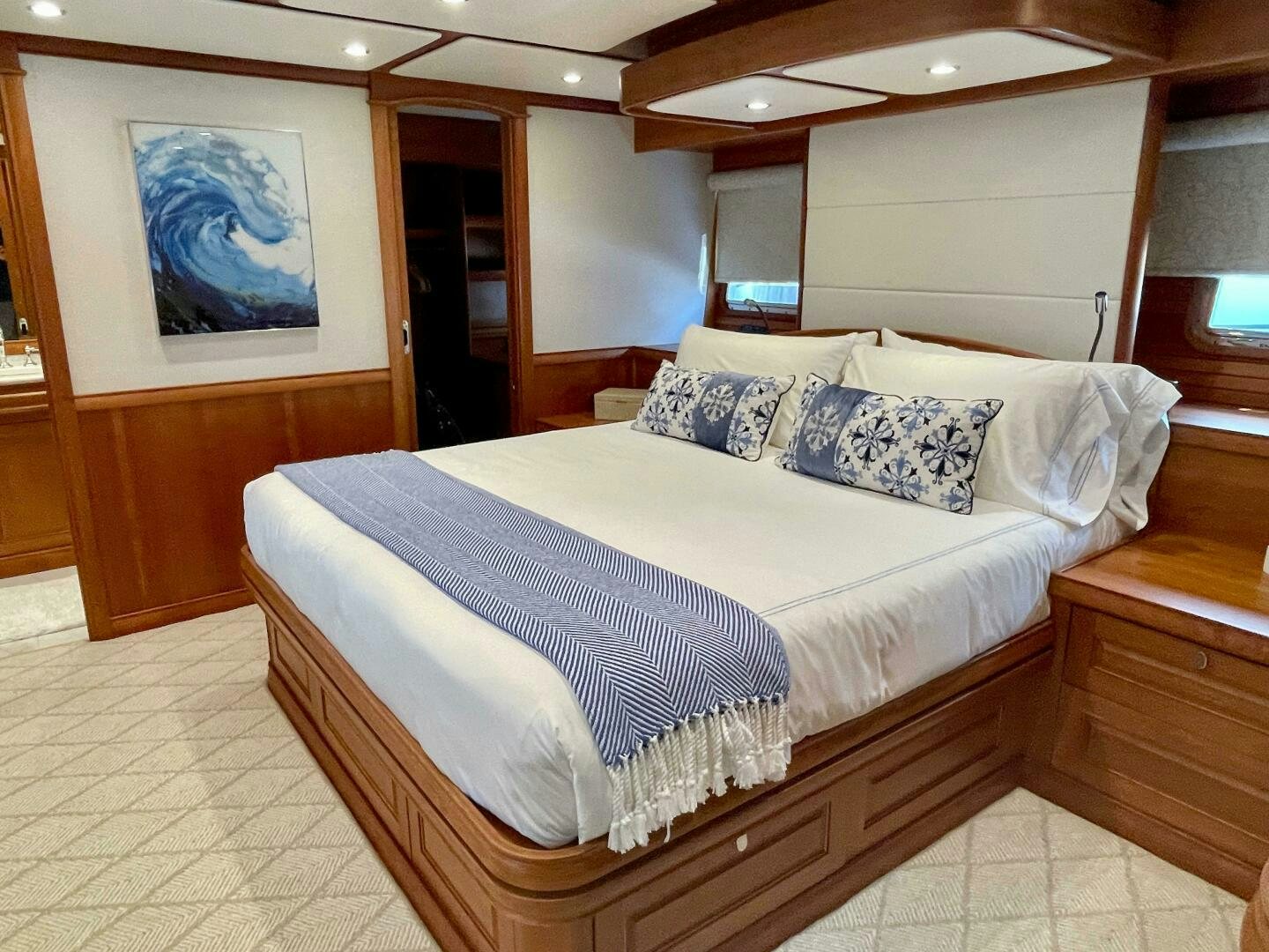 a bed with a blue and white comforter aboard WHIRL AWAY Yacht for Sale