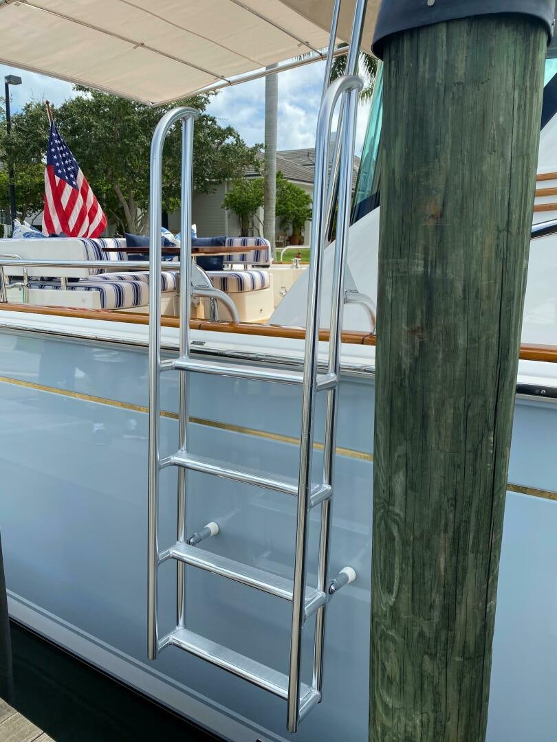 a boat with a flag on the deck aboard WHIRL AWAY Yacht for Sale
