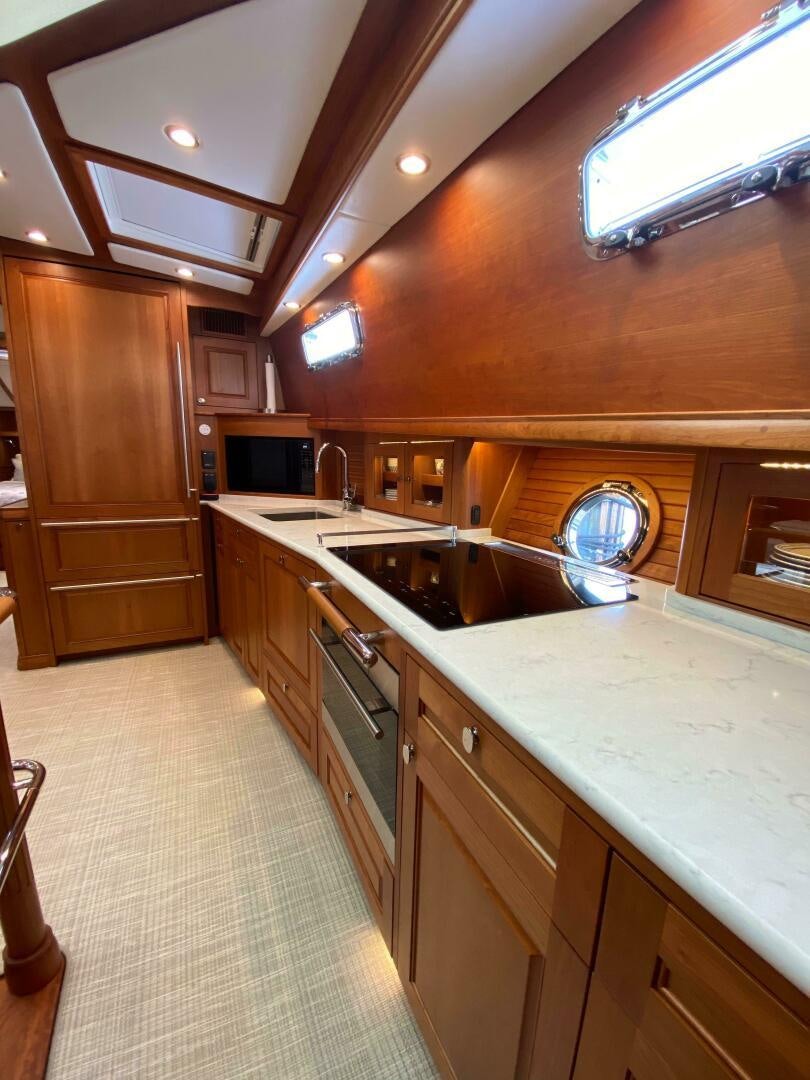 a kitchen with wooden cabinets aboard WHIRL AWAY Yacht for Sale