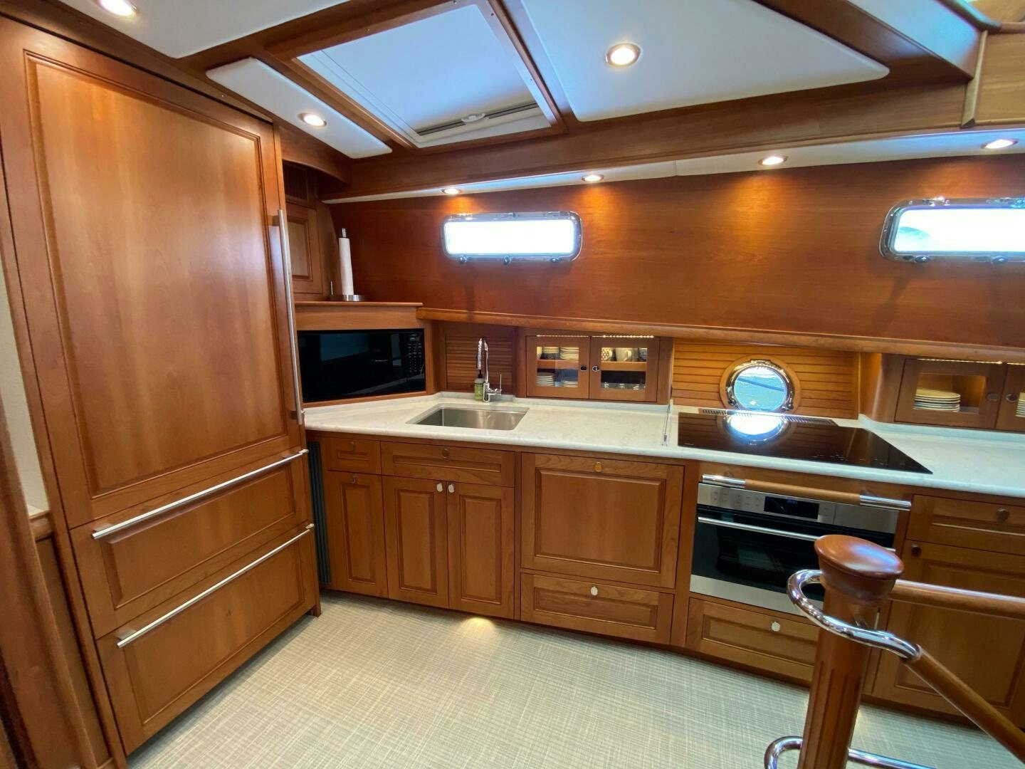 a kitchen with wooden cabinets aboard WHIRL AWAY Yacht for Sale
