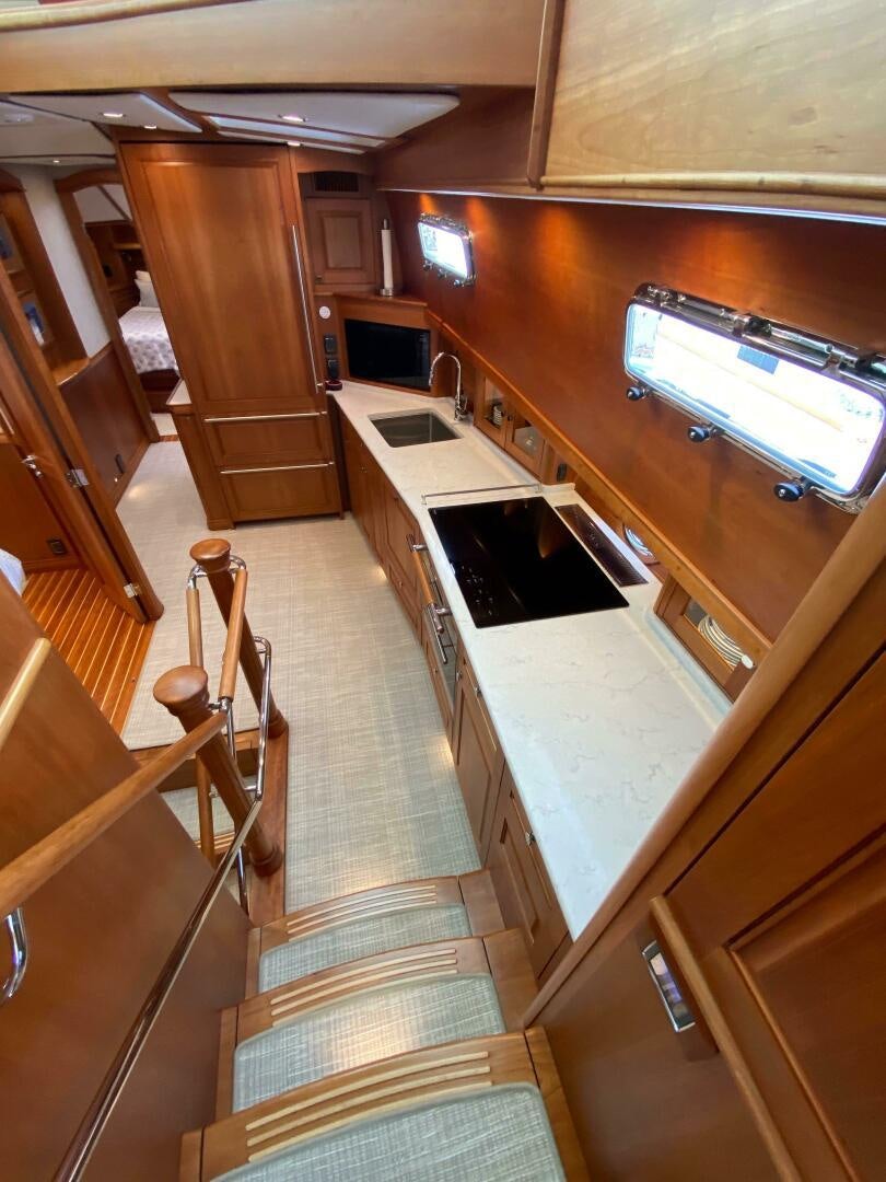 a kitchen with wooden cabinets aboard WHIRL AWAY Yacht for Sale