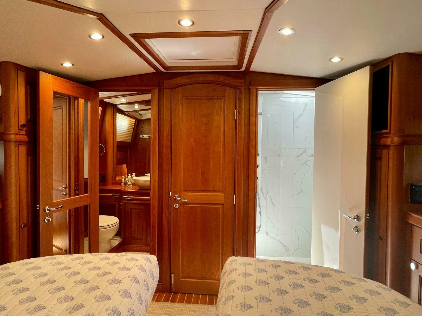 a bedroom with a bed and a closet aboard WHIRL AWAY Yacht for Sale