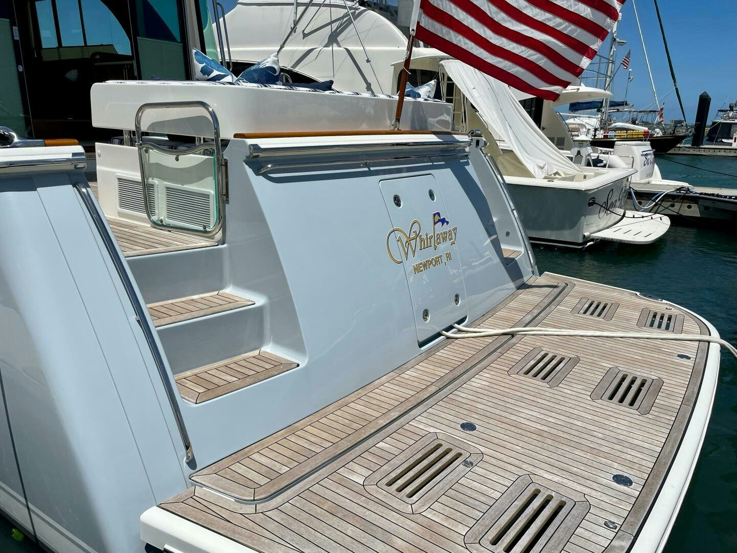 a boat with a flag on the front aboard WHIRL AWAY Yacht for Sale