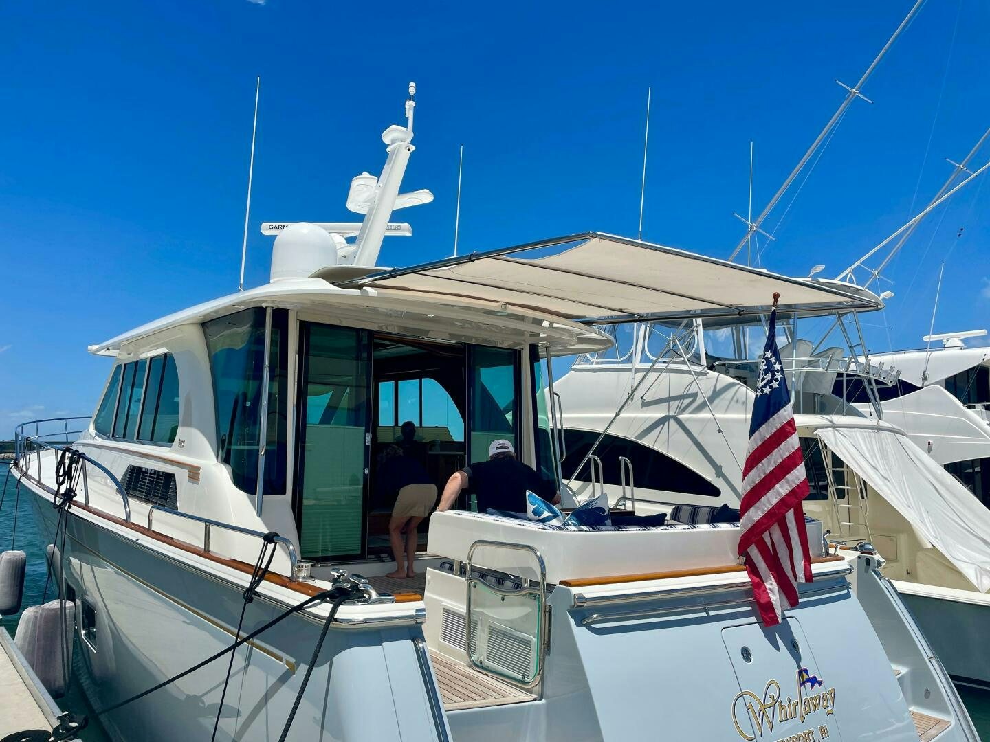 a boat with a flag on the front aboard WHIRL AWAY Yacht for Sale