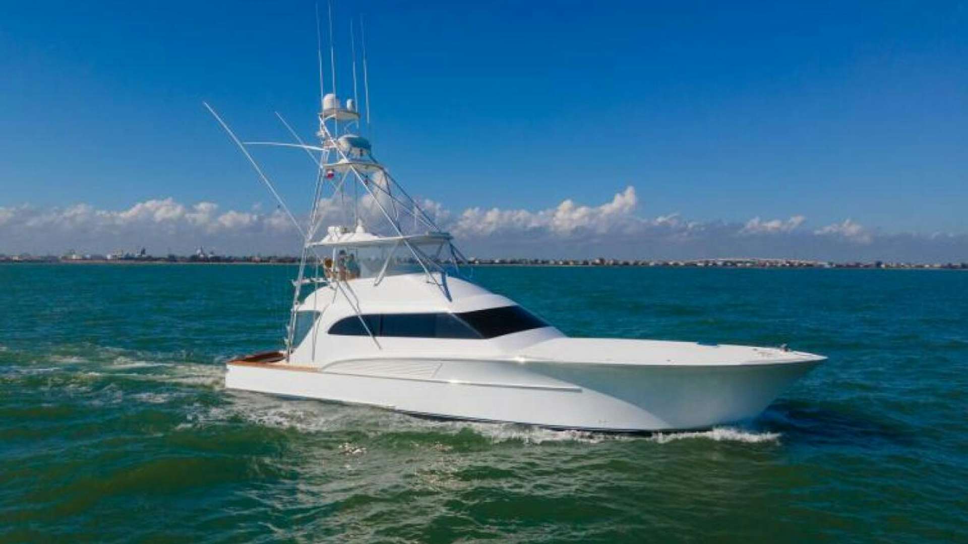a white boat in the water aboard LET IT RIDE Yacht for Sale
