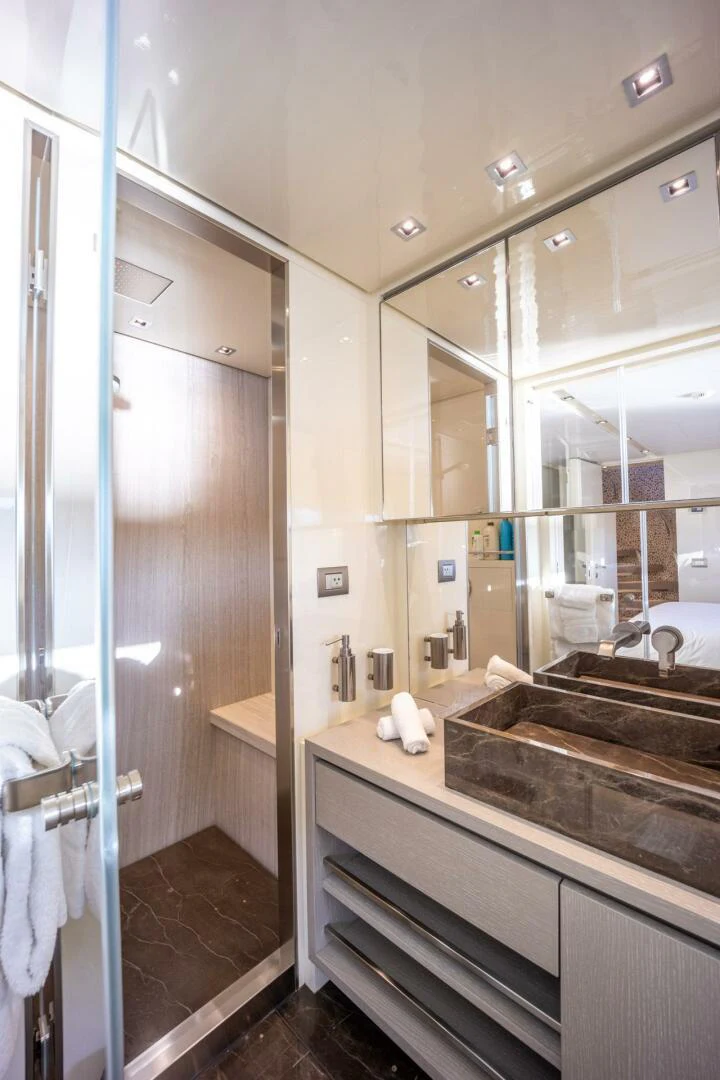 a bathroom with a glass shower aboard PHOENIX Yacht for Sale