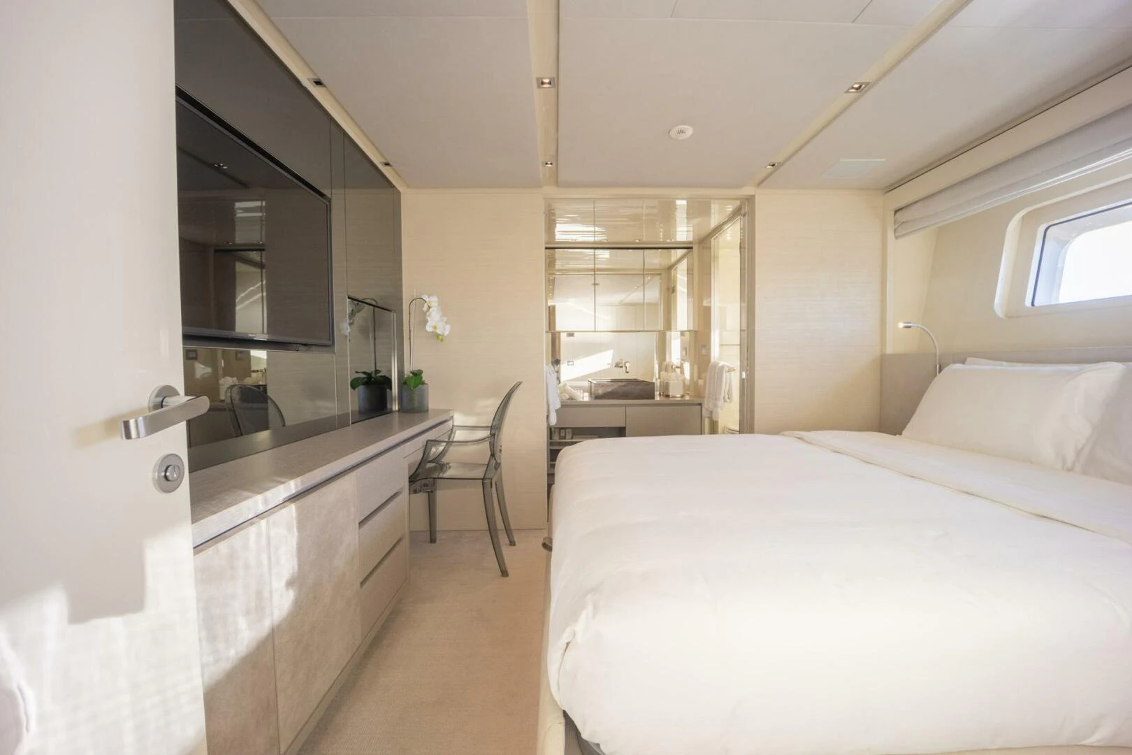 a bedroom with a bed and a desk aboard PHOENIX Yacht for Sale