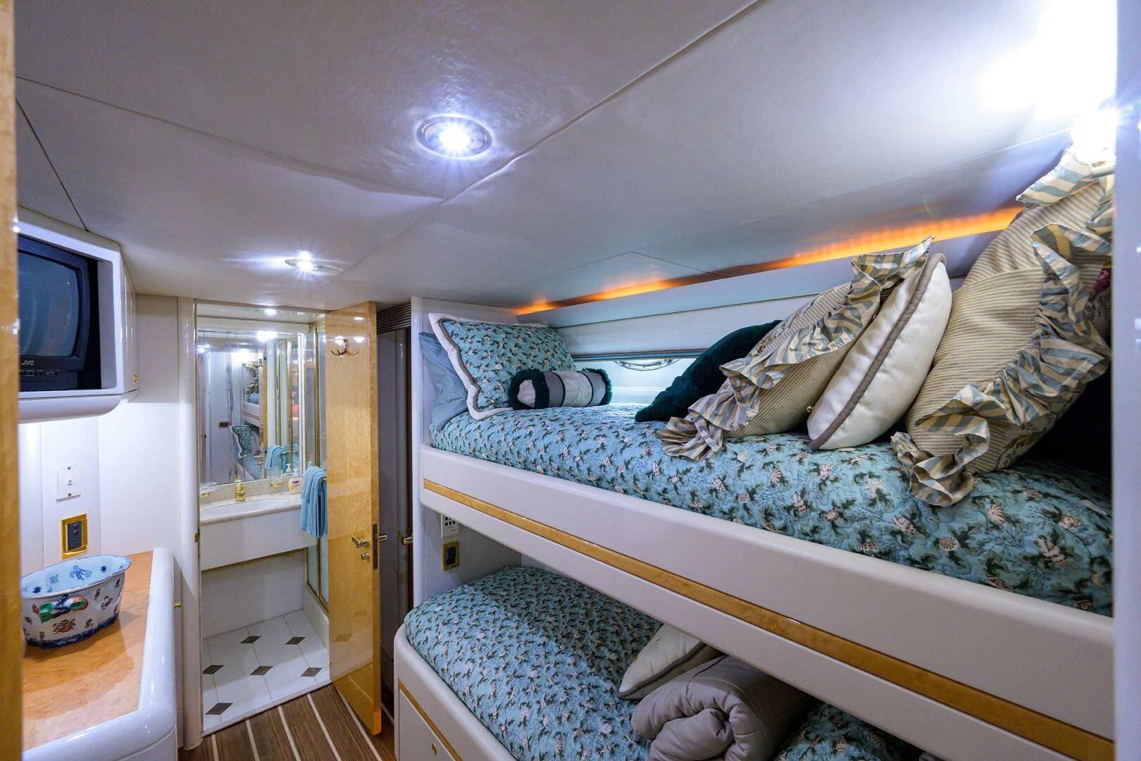 a bedroom with a bed and a television aboard LOST TEXAN Yacht for Sale