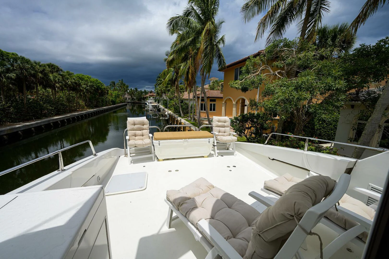 a lounge chair on a deck overlooking a body of water aboard LOST TEXAN Yacht for Sale