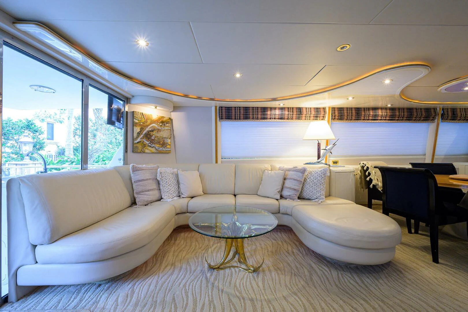 a living room with a large white couch and a large window aboard LOST TEXAN Yacht for Sale