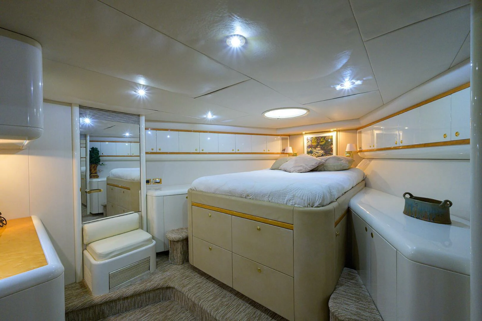 a bedroom with a bed and a mirror aboard LOST TEXAN Yacht for Sale
