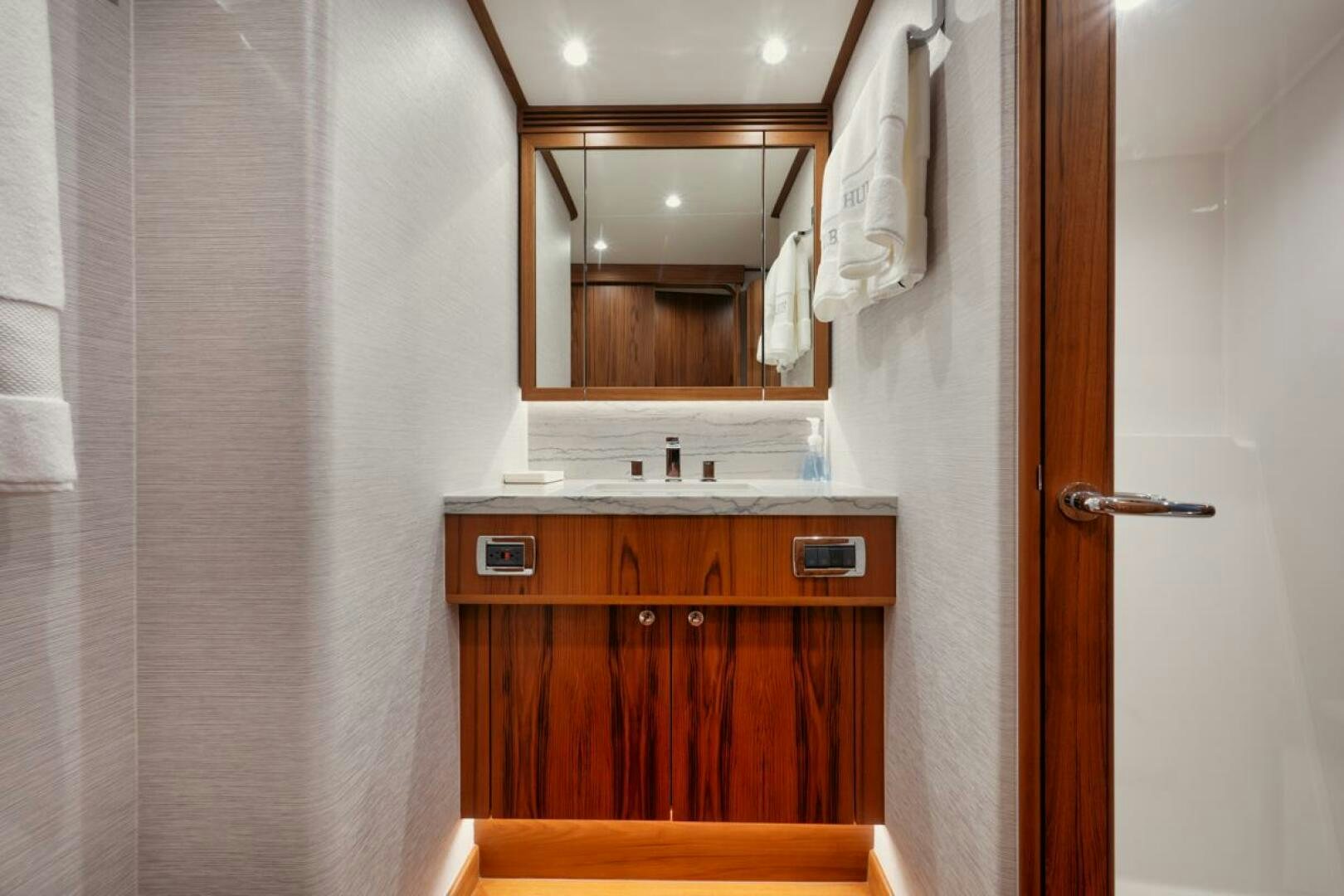 a bathroom with a mirror and sink aboard HULLBILLY Yacht for Sale
