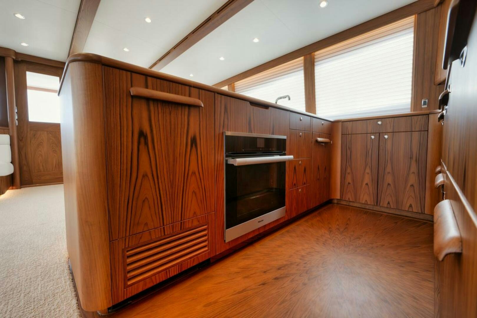 a kitchen with wooden cabinets aboard HULLBILLY Yacht for Sale