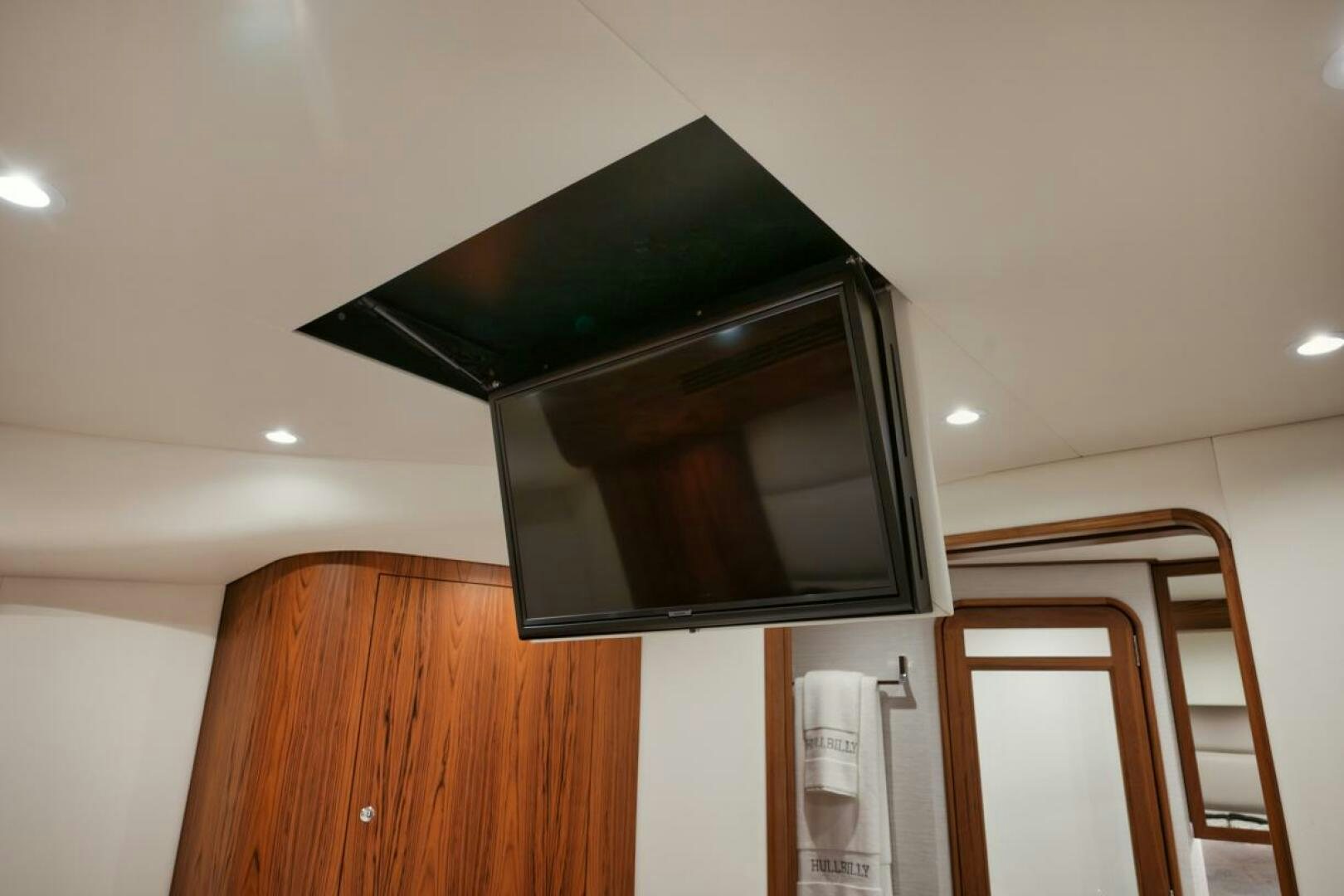 a black microwave on a wooden shelf aboard HULLBILLY Yacht for Sale