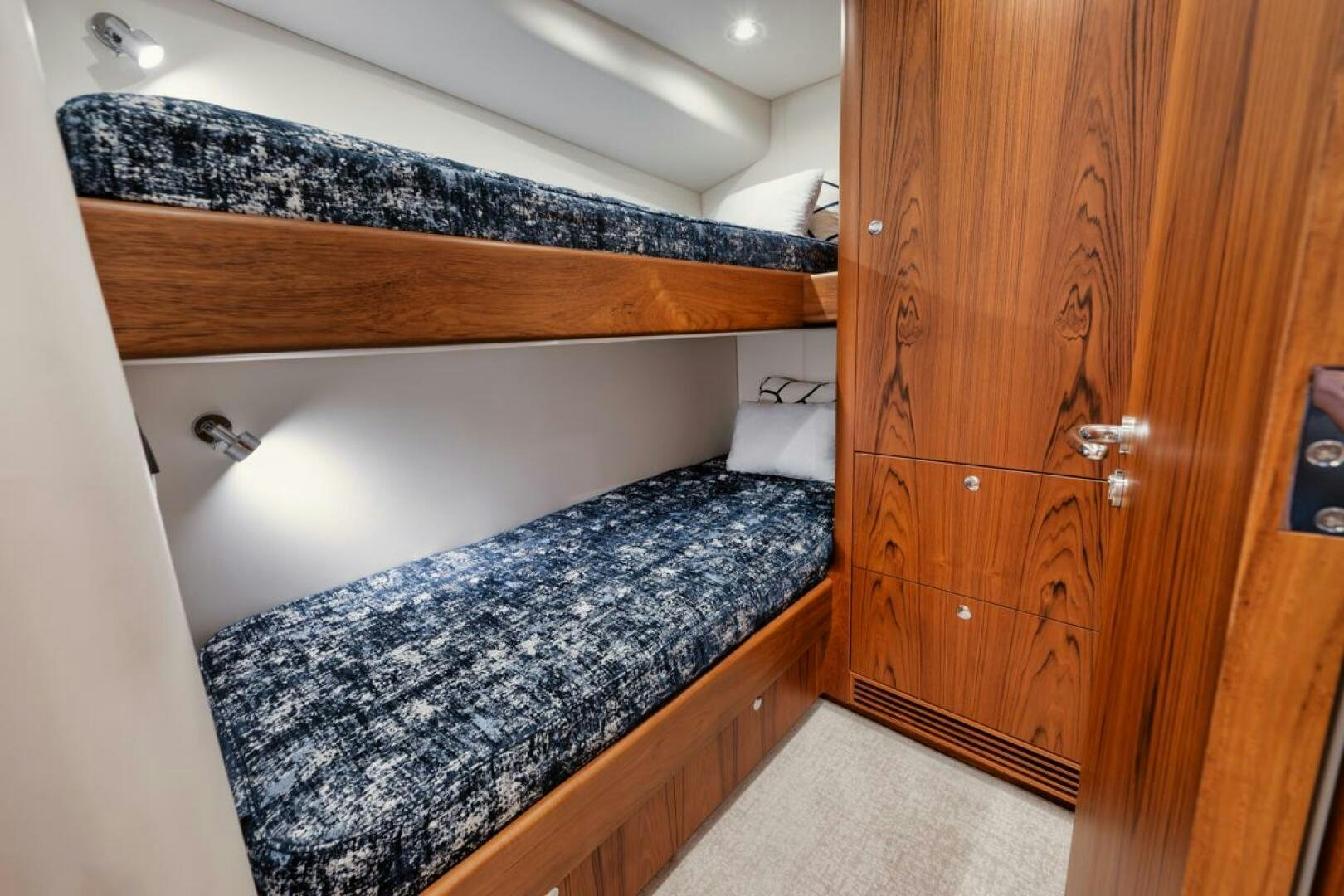 a bedroom with a wood cabinet aboard HULLBILLY Yacht for Sale