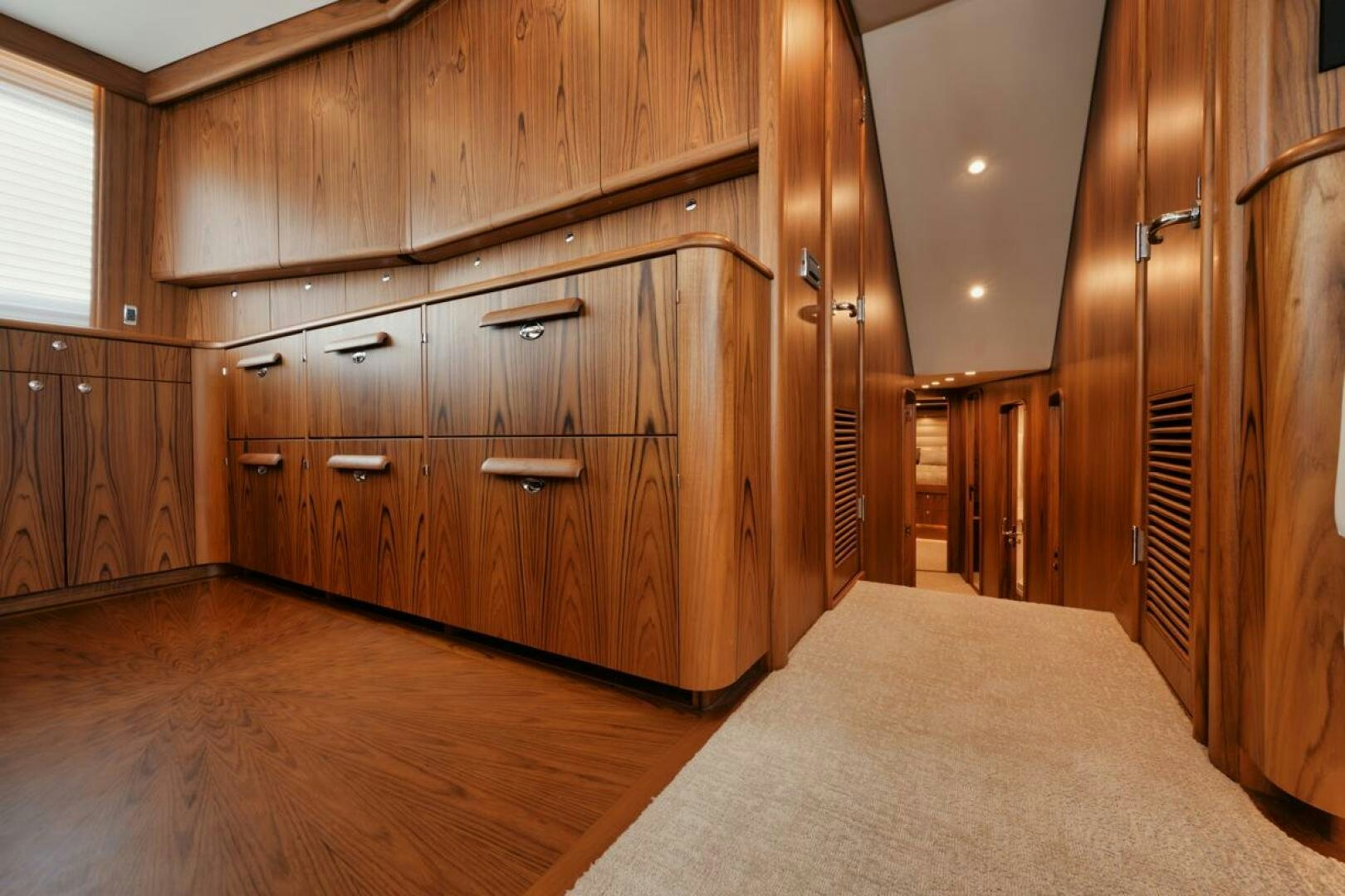 a bedroom with wood cabinets aboard HULLBILLY Yacht for Sale
