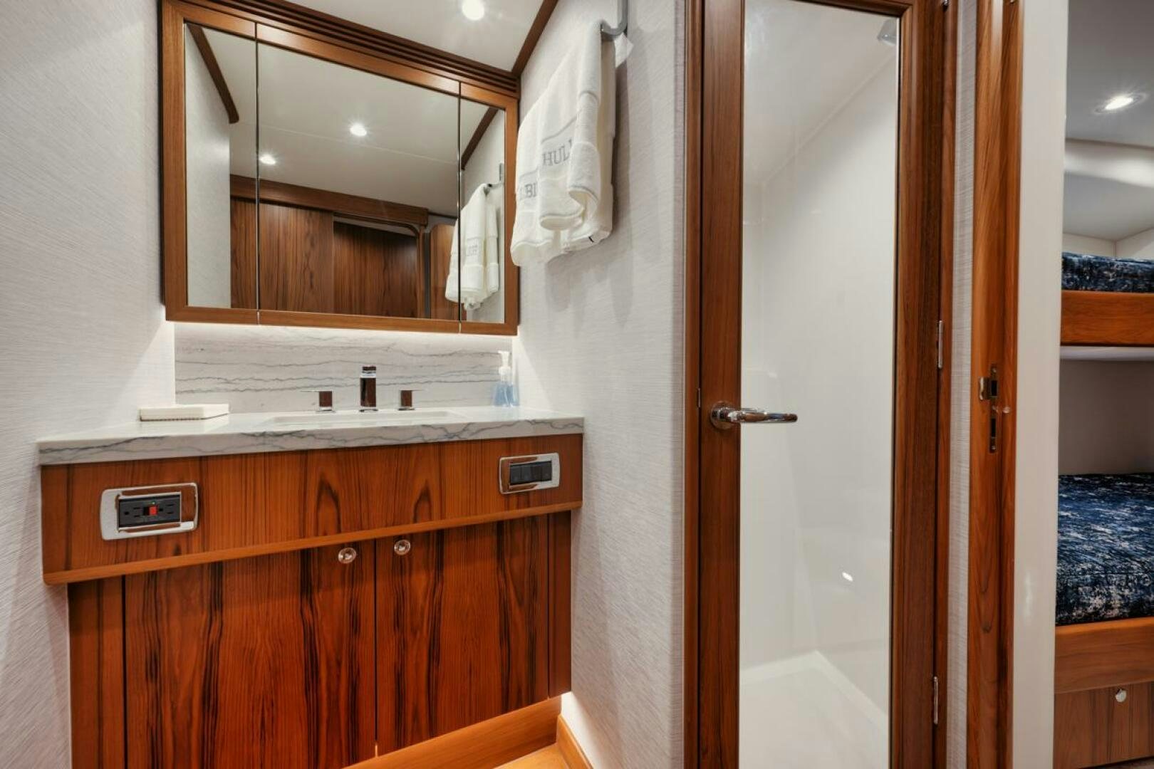 a bathroom with a mirror and a sink aboard HULLBILLY Yacht for Sale