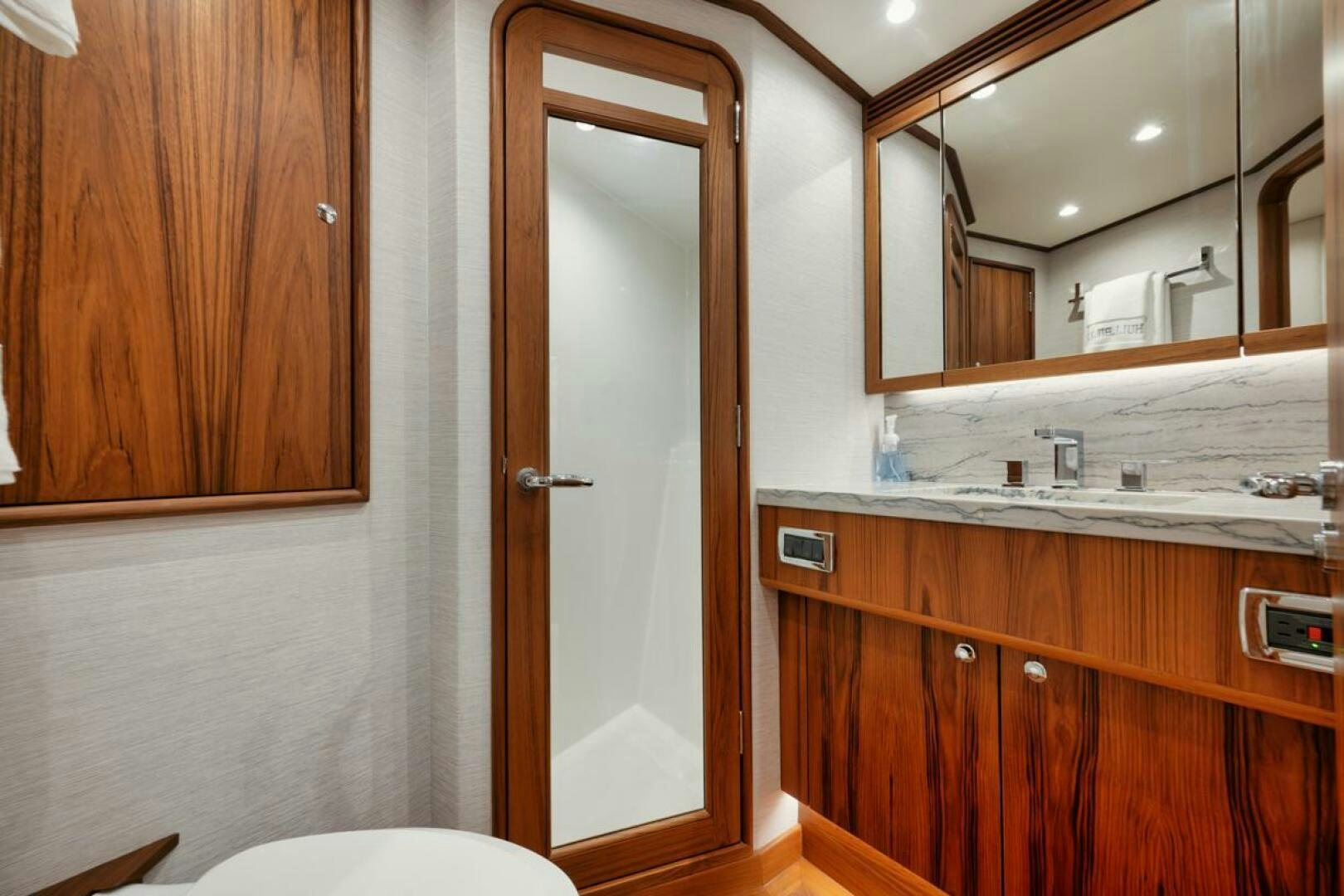 a bathroom with a mirror and sink aboard HULLBILLY Yacht for Sale