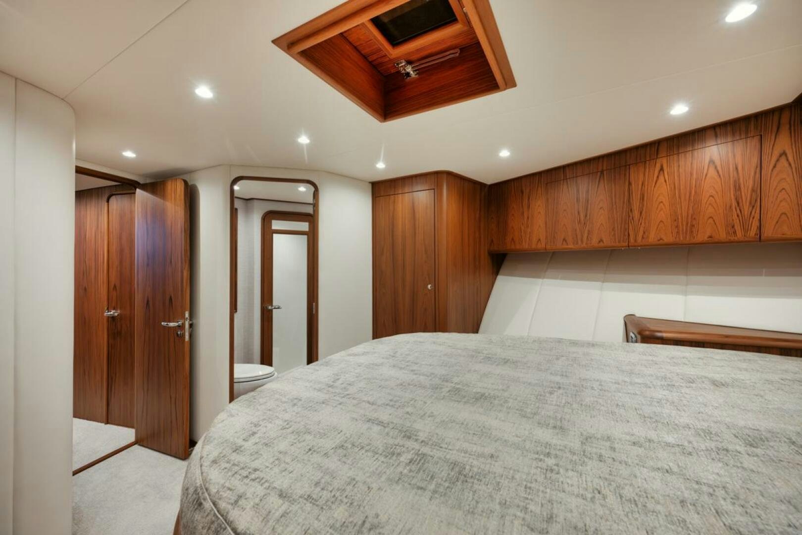 a large bedroom with a large bed aboard HULLBILLY Yacht for Sale