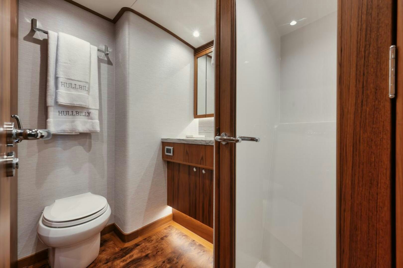 a bathroom with a toilet and a sink aboard HULLBILLY Yacht for Sale