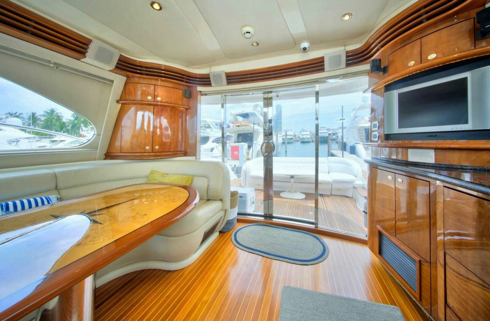 a living room with a sliding glass door aboard FAIRYTALE Yacht for Sale