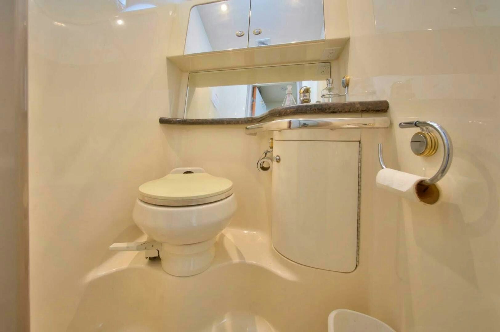 a bathroom with a toilet and sink aboard FAIRYTALE Yacht for Sale