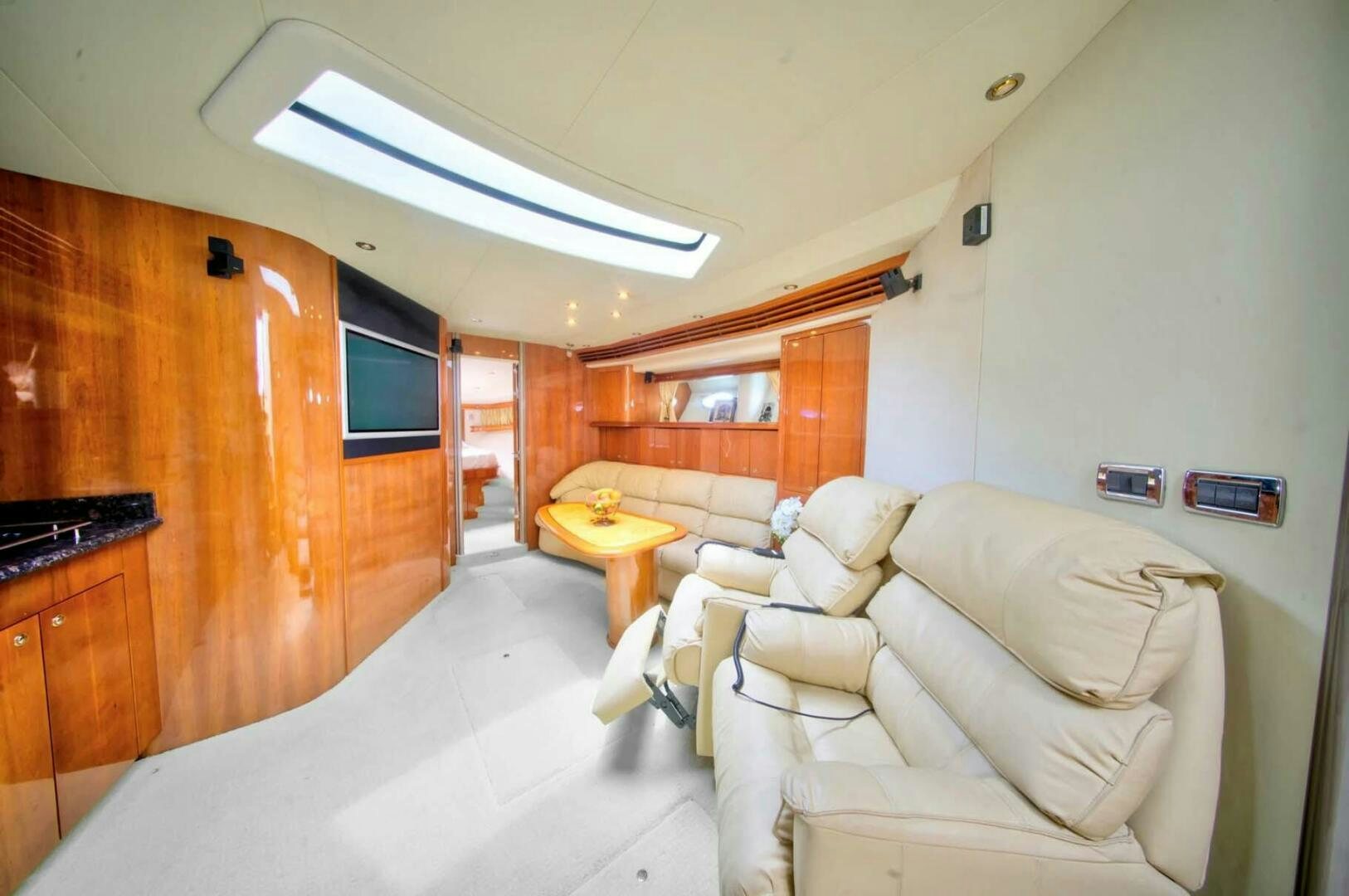 a living room with a couch and a table aboard FAIRYTALE Yacht for Sale