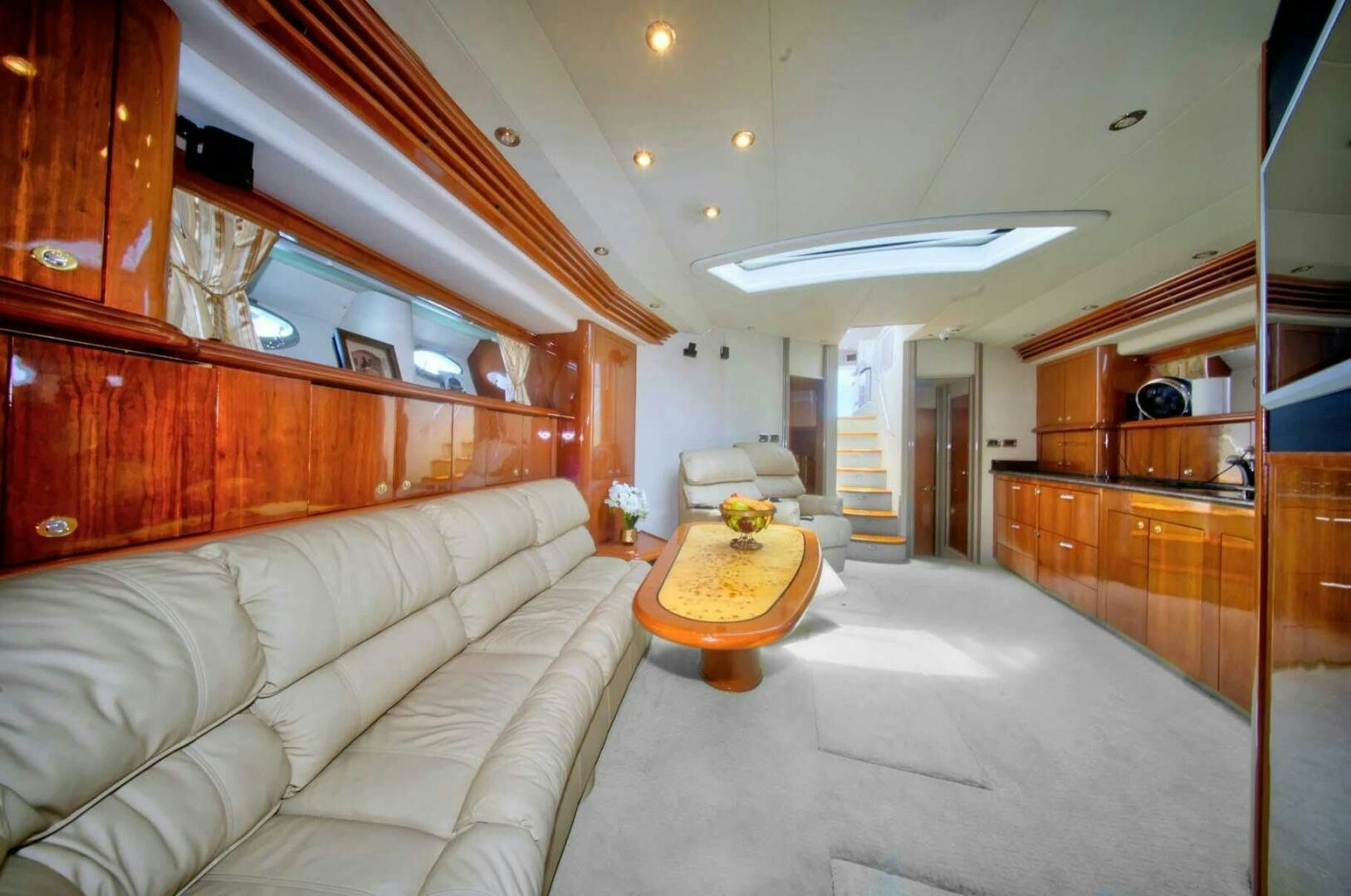 a living room with a couch and a table aboard FAIRYTALE Yacht for Sale