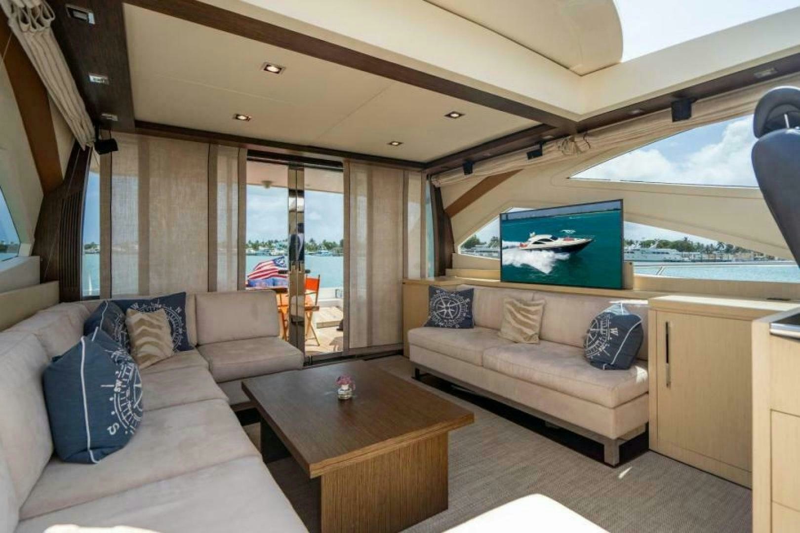 a living room with a couch and a tv aboard EQUINOX Yacht for Sale