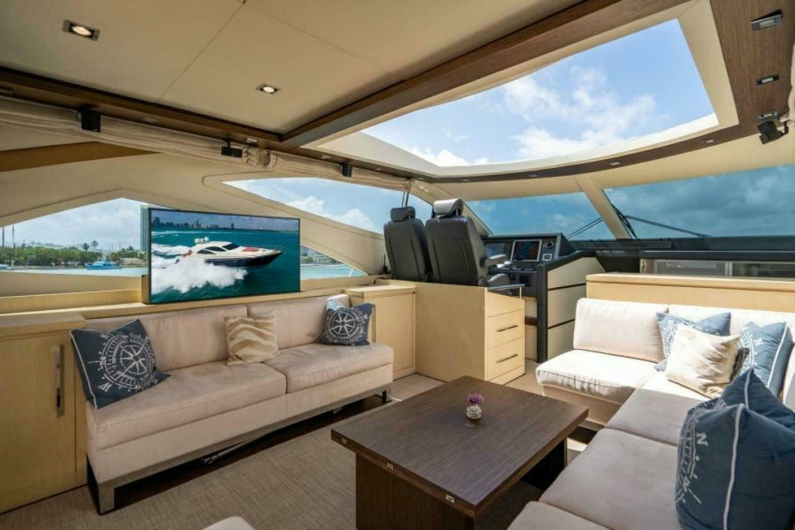 a living room with a large window aboard EQUINOX Yacht for Sale