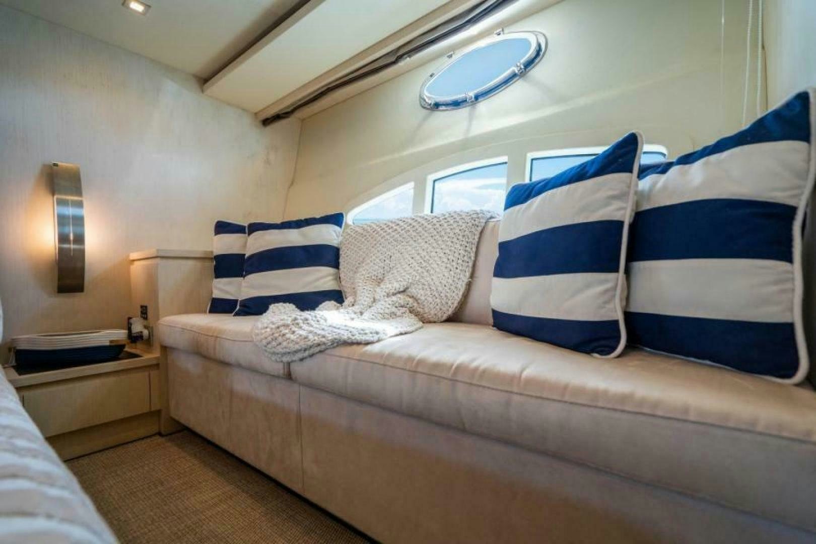 a couch with pillows aboard EQUINOX Yacht for Sale