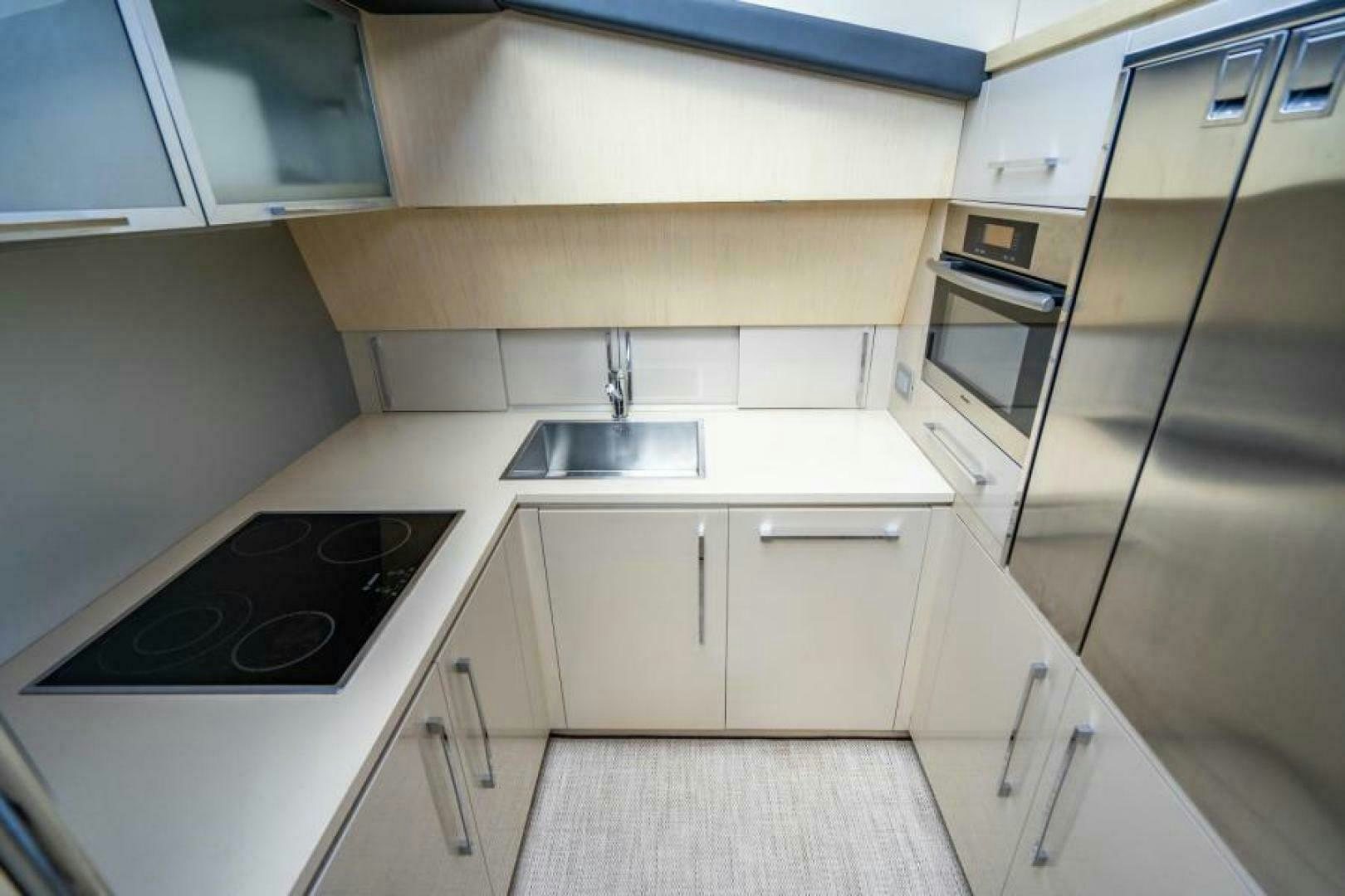 a kitchen with white cabinets aboard EQUINOX Yacht for Sale