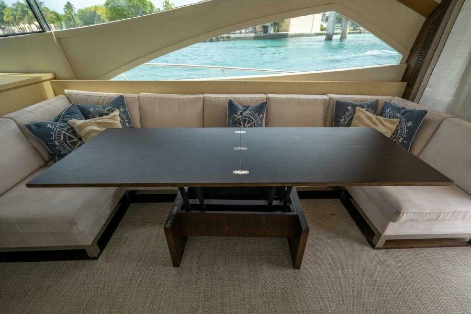 a couch with a table in the back aboard EQUINOX Yacht for Sale
