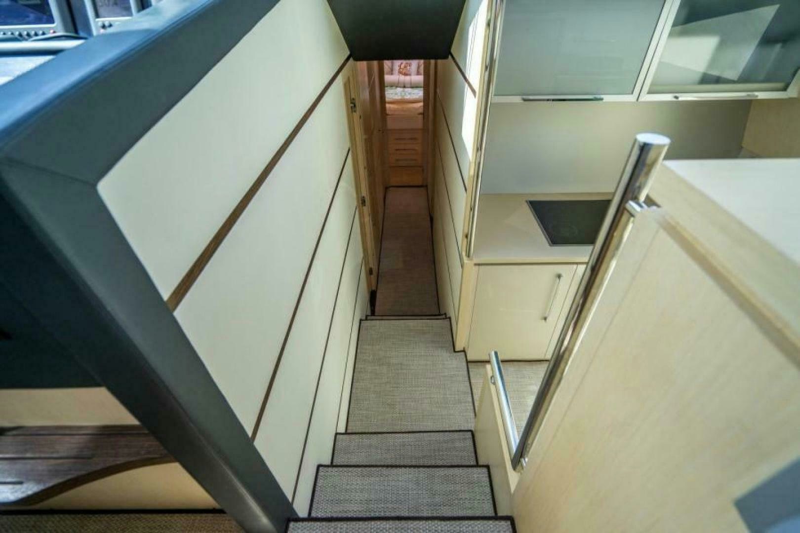 a flight of stairs leading to a room with a railing aboard EQUINOX Yacht for Sale