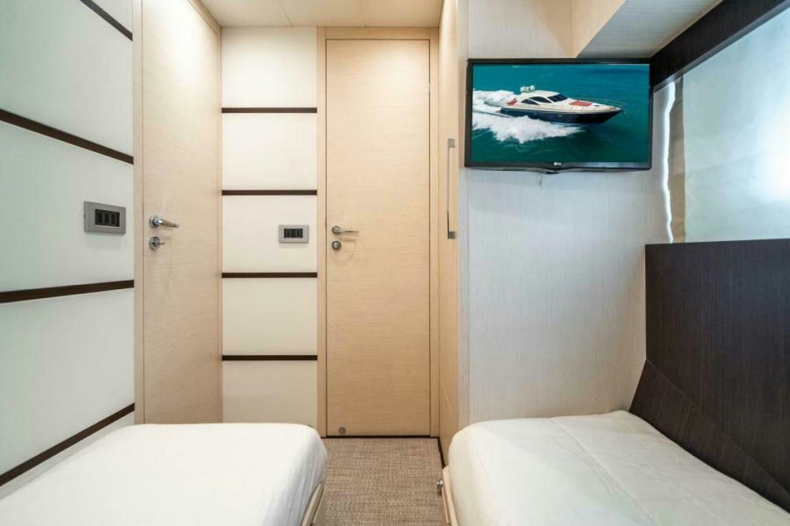a room with a couch and a television aboard EQUINOX Yacht for Sale