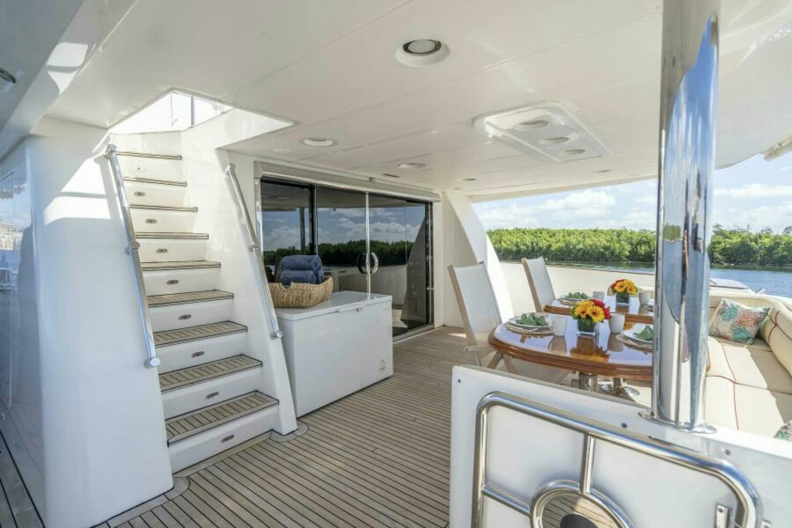 a room with a table and chairs aboard SIXTY SIX Yacht for Sale