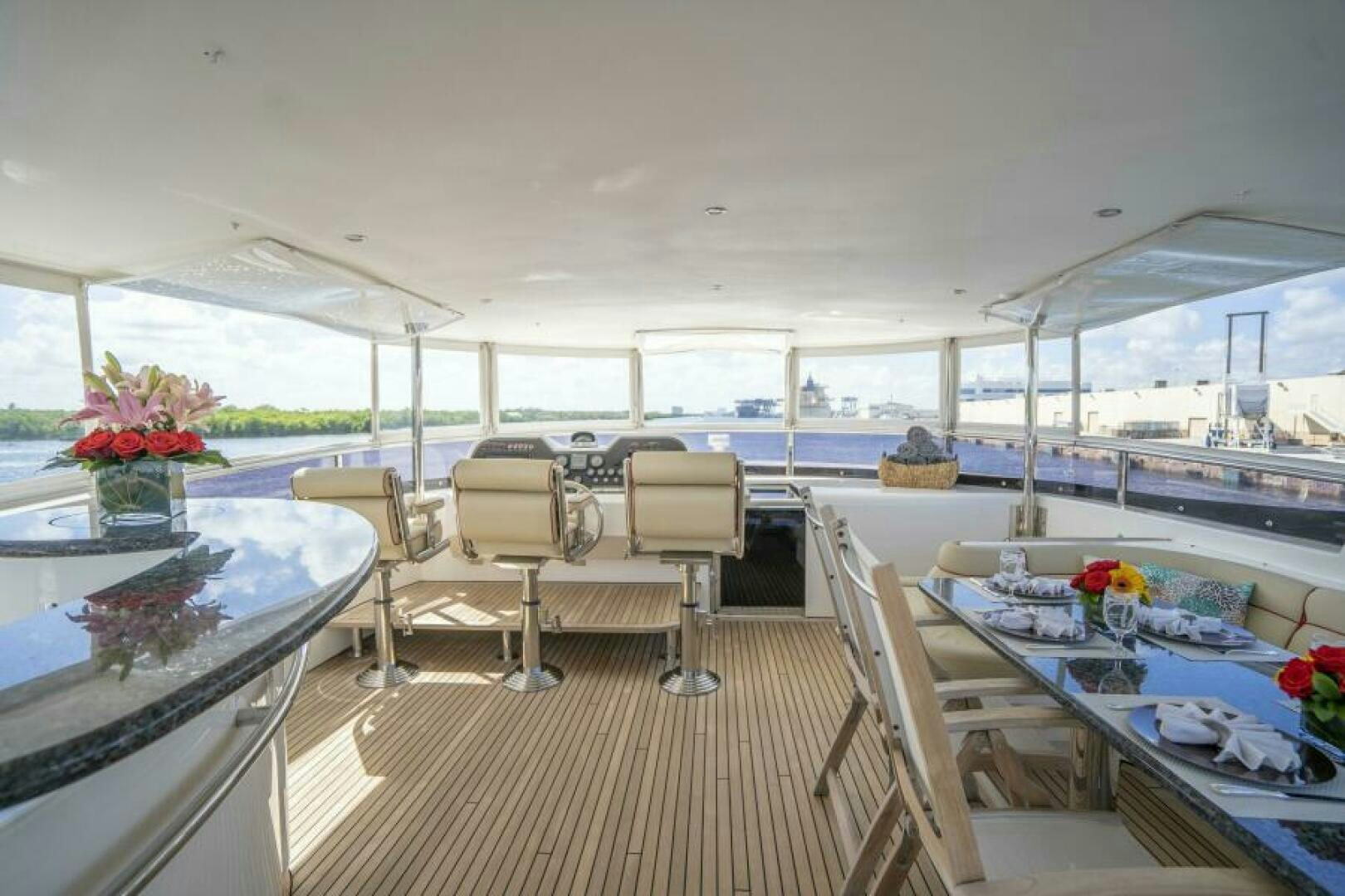 a room with a table and chairs aboard SIXTY SIX Yacht for Sale