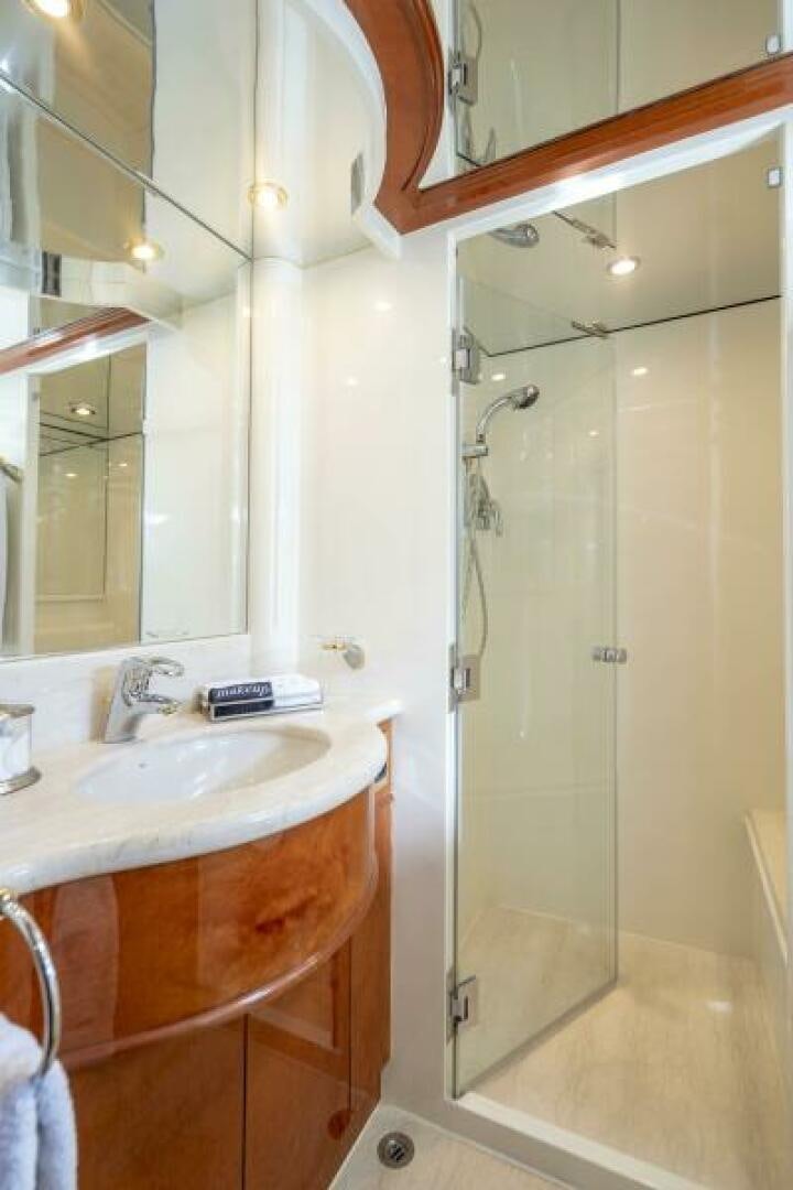 a bathroom with a shower and sink aboard SIXTY SIX Yacht for Sale
