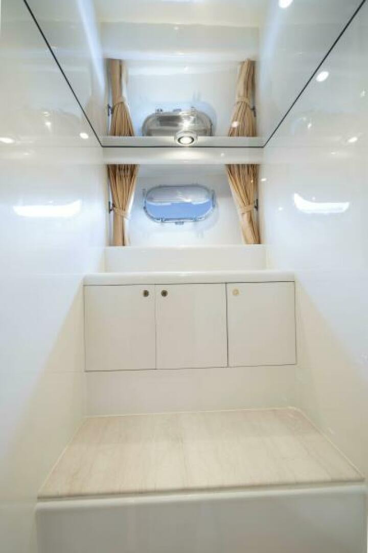 a white bathroom with a glass shelf aboard SIXTY SIX Yacht for Sale