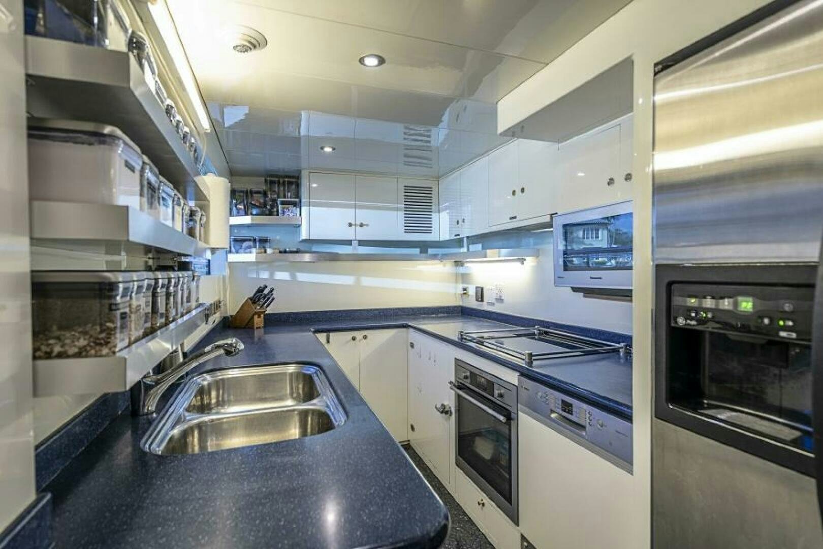 a kitchen with a sink and stove aboard SIXTY SIX Yacht for Sale