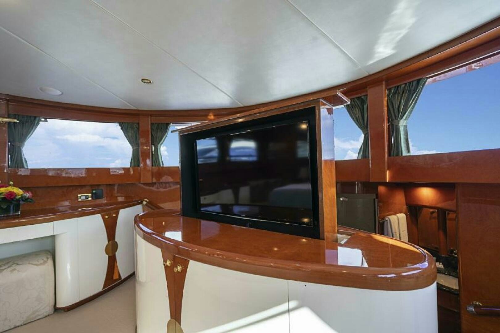 a room with a tv and a table aboard SIXTY SIX Yacht for Sale