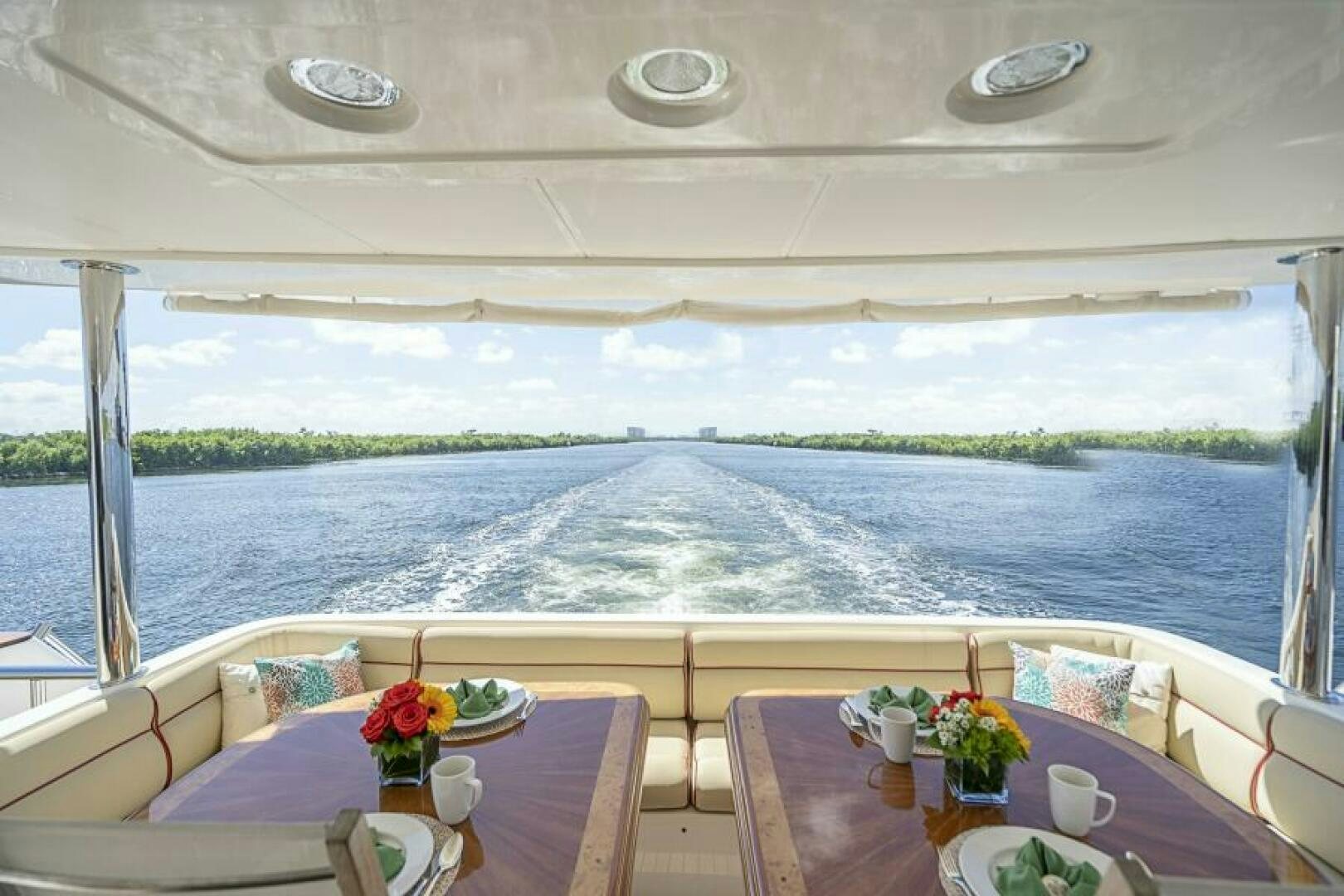 a table with a view of a body of water aboard SIXTY SIX Yacht for Sale