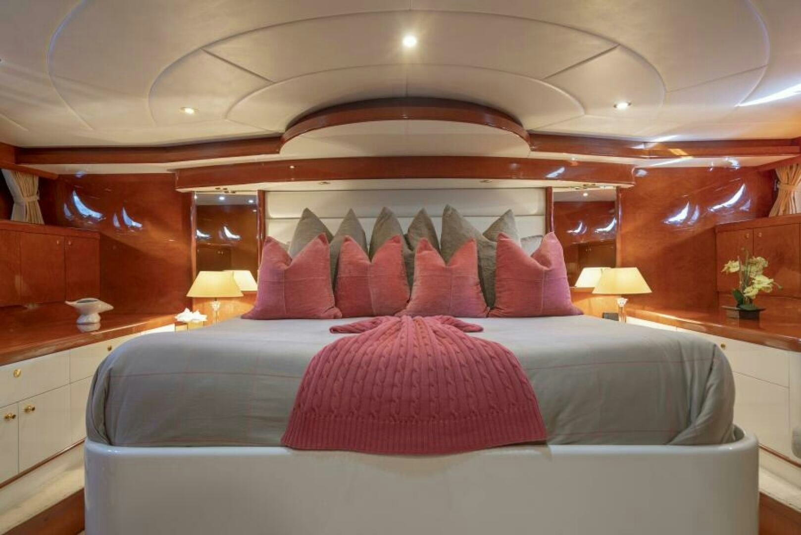 a bed with pink pillows aboard SIXTY SIX Yacht for Sale