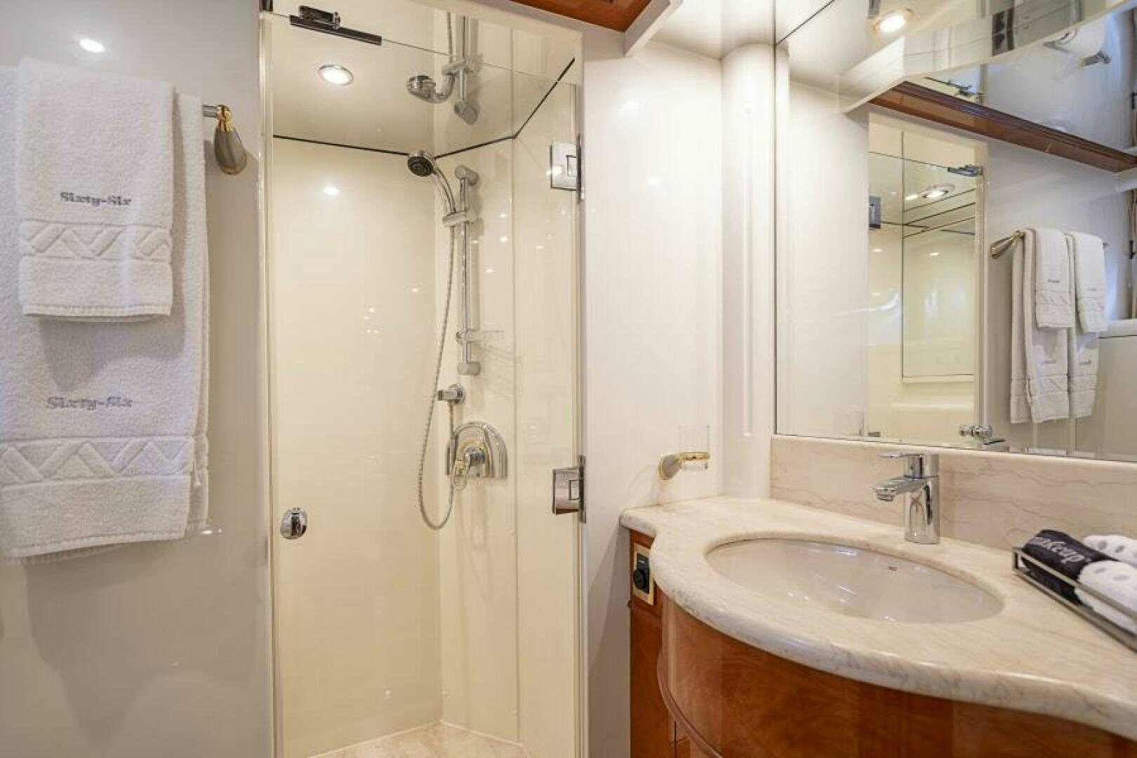 a bathroom with a shower and sink aboard SIXTY SIX Yacht for Sale