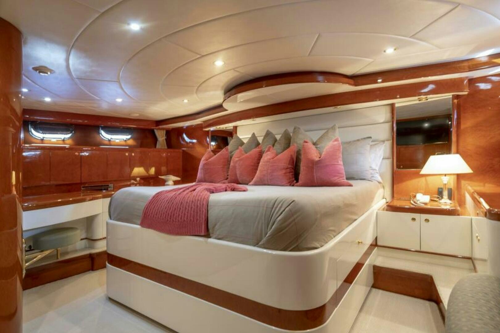 a room with a bed and a mirror aboard SIXTY SIX Yacht for Sale