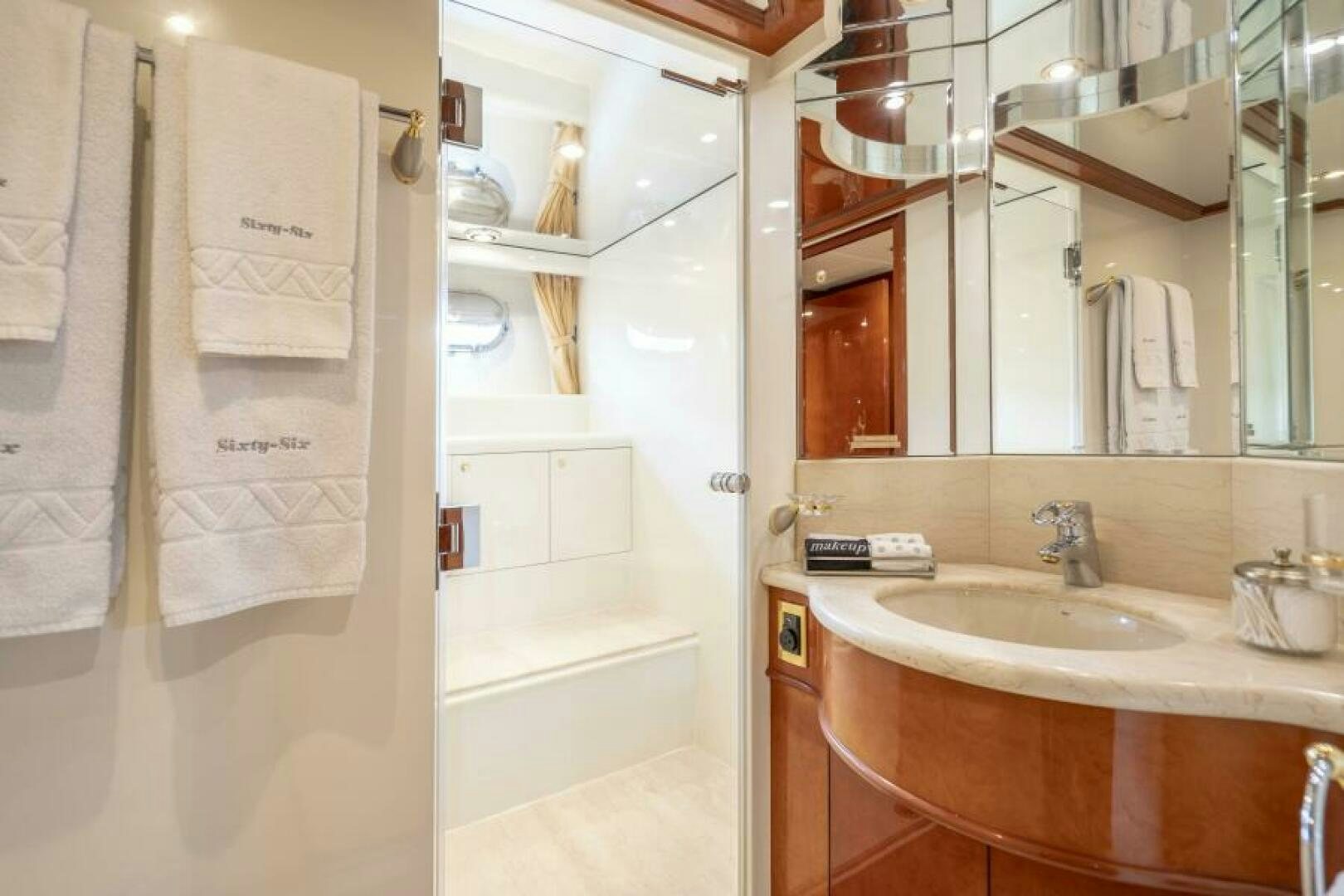 a bathroom with a sink and a mirror aboard SIXTY SIX Yacht for Sale