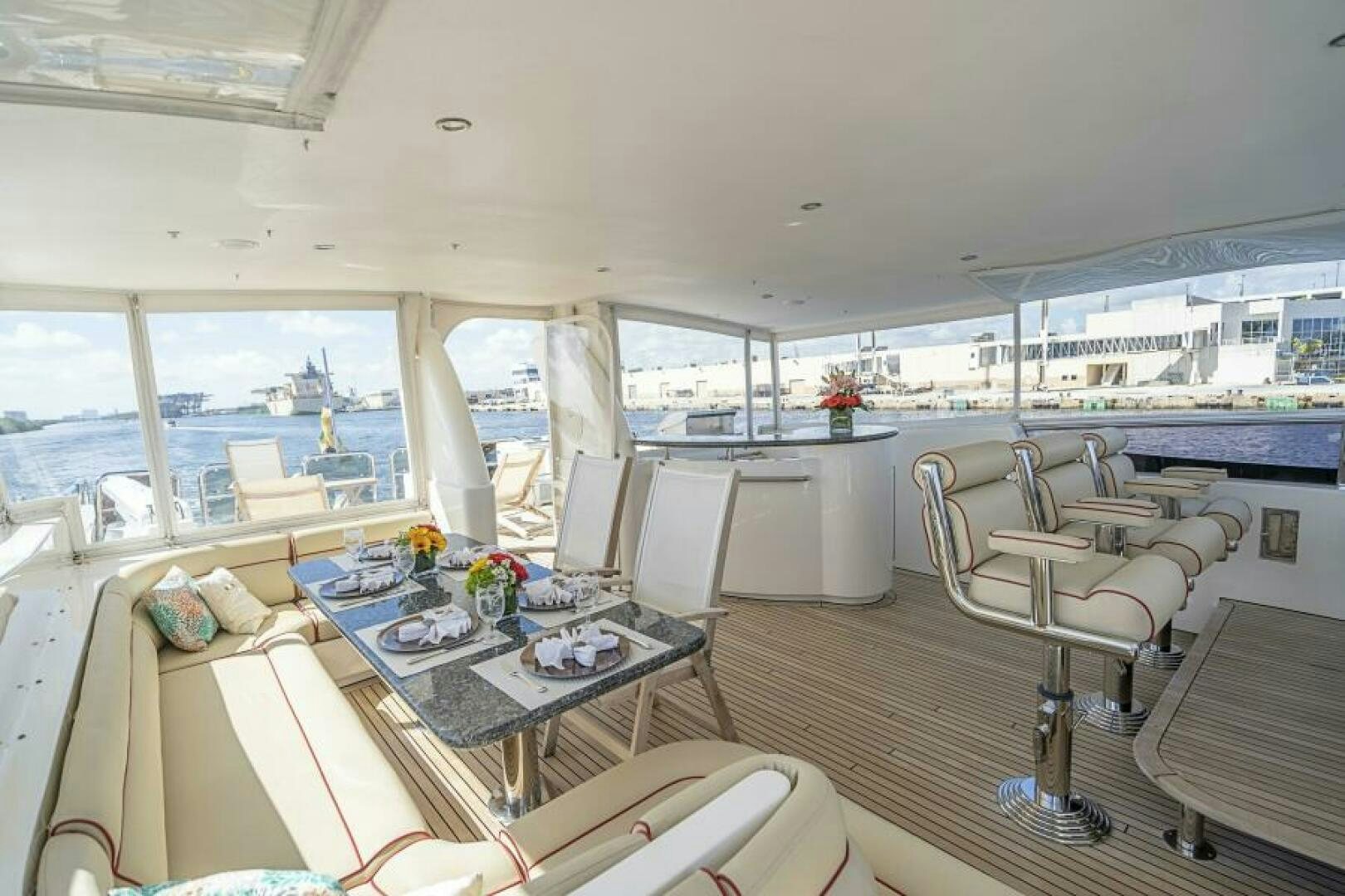 a room with a table chairs and a large window aboard SIXTY SIX Yacht for Sale