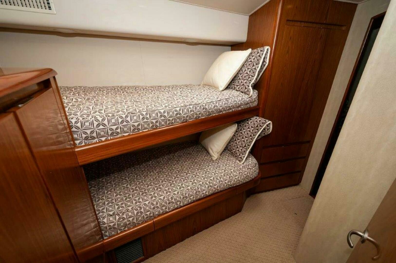 a bed with a white pillow aboard BAREFOOT DRIVE Yacht for Sale