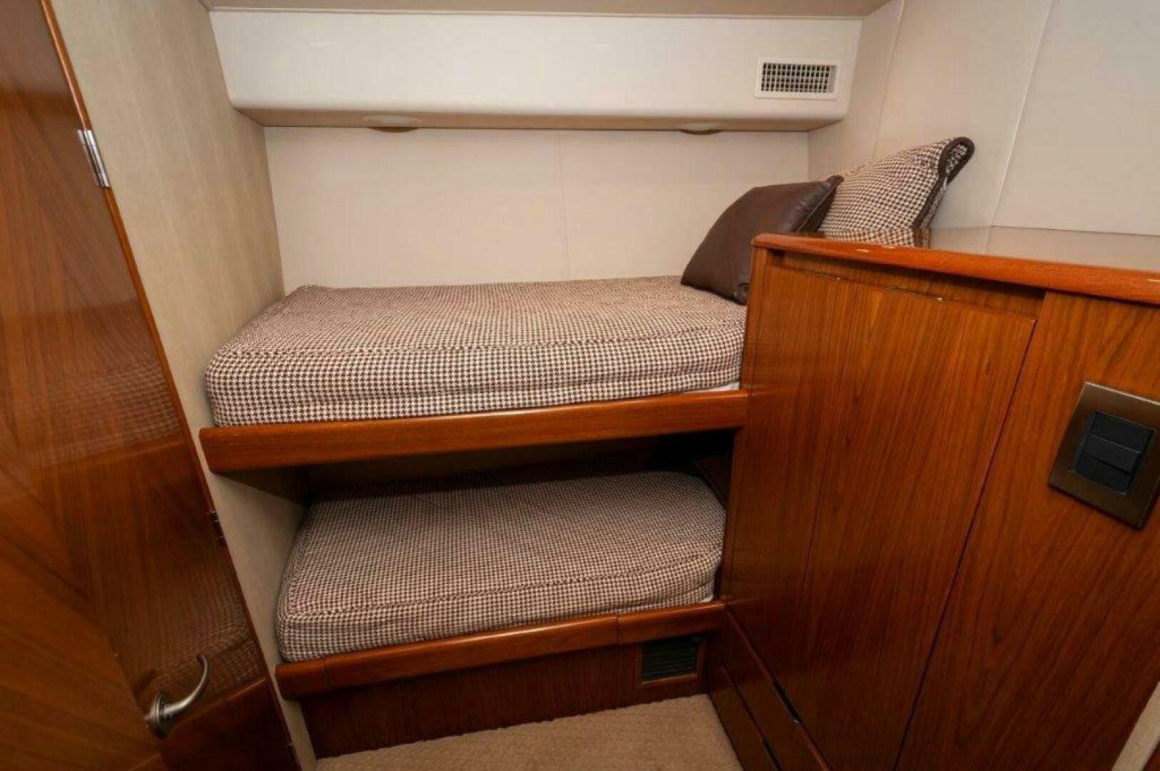 a bed with a wooden headboard aboard BAREFOOT DRIVE Yacht for Sale