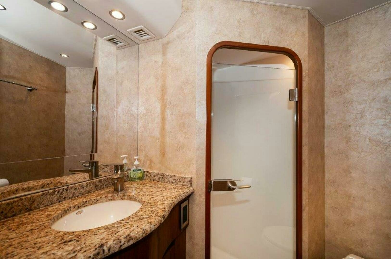 a bathroom with a large mirror aboard BAREFOOT DRIVE Yacht for Sale